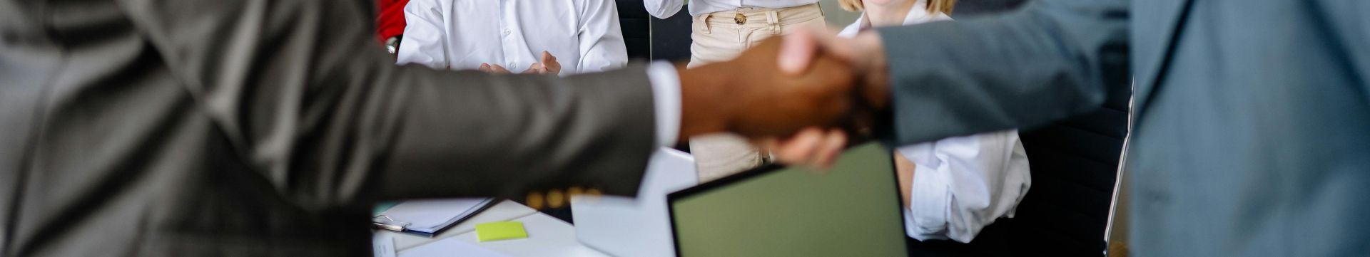 Colleagues Looking at Men in an Agreement